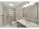 Modern bathroom features a glass-door shower, toilet, vanity, and large mirror at 3519 Oak Knoll Dr, Marietta, GA 30068