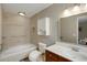 Cozy bathroom featuring tile flooring, a built-in jacuzzi tub, toilet, vanity, and white cabinets at 3519 Oak Knoll Dr, Marietta, GA 30068