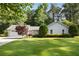 Charming single-story home featuring a well-maintained lawn, attached garage, and mature landscaping at 3519 Oak Knoll Dr, Marietta, GA 30068