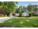 Well-kept single-story home with a green lawn and a mix of stone and siding exterior at 3519 Oak Knoll Dr, Marietta, GA 30068