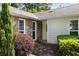 Close up of the entrance with stone exterior, clean white door, and mature landscaping elements at 3519 Oak Knoll Dr, Marietta, GA 30068