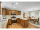 Kitchen featuring stainless steel appliances, wooden cabinets, breakfast bar, and an adjacent dining area at 3519 Oak Knoll Dr, Marietta, GA 30068