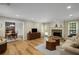 Open concept living room featuring a fireplace, hardwood floors, and adjacent dining area at 3519 Oak Knoll Dr, Marietta, GA 30068