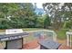 Backyard patio area with a large grill and chairs with cushions on the patio at 368 Lambeth Dr, Hiram, GA 30141