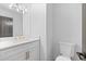 Bathroom featuring a sleek vanity with gold fixtures and a modern toilet at 4166 Riverhill Ne Ct, Roswell, GA 30075