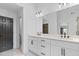 Bathroom with double sinks, quartz counters, modern fixtures, and door to toilet area at 4166 Riverhill Ne Ct, Roswell, GA 30075