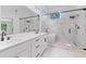This bathroom has double sinks, quartz counters, modern fixtures, tub, and glass shower at 4166 Riverhill Ne Ct, Roswell, GA 30075