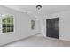 This carpeted bedroom has two windows, trim, and a closet with double doors at 4166 Riverhill Ne Ct, Roswell, GA 30075