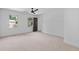 Spacious bedroom featuring neutral carpet, two windows with trim, and a ceiling fan at 4166 Riverhill Ne Ct, Roswell, GA 30075