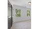 This carpeted bedroom has two windows and a closet with double doors at 4166 Riverhill Ne Ct, Roswell, GA 30075