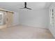 Spacious bedroom with carpet flooring and a barn door leading to a bathroom at 4166 Riverhill Ne Ct, Roswell, GA 30075