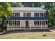 Charming two-story home featuring a welcoming front porch, well-maintained lawn, and classic design at 4166 Riverhill Ne Ct, Roswell, GA 30075
