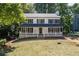 Charming two-story home with inviting front porch, manicured lawn, and traditional architectural details at 4166 Riverhill Ne Ct, Roswell, GA 30075