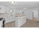 Modern kitchen with white cabinetry, center island, and stylish backsplash, offering a clean and functional design at 4166 Riverhill Ne Ct, Roswell, GA 30075