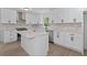 A modern kitchen with white cabinetry, stainless steel appliances, and a large island at 4166 Riverhill Ne Ct, Roswell, GA 30075