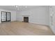 Spacious living room with a fireplace, hardwood floors, and bright windows at 4166 Riverhill Ne Ct, Roswell, GA 30075