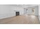 Spacious living room with a fireplace, hardwood floors, and bright windows at 4166 Riverhill Ne Ct, Roswell, GA 30075