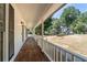 Inviting porch showcasing wooden floors and ample space, perfect for relaxing and enjoying neighborhood views at 4166 Riverhill Ne Ct, Roswell, GA 30075