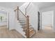 Elegant staircase featuring wood steps, black iron railings, and white trim, creating a striking focal point at 4166 Riverhill Ne Ct, Roswell, GA 30075