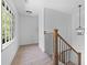 Stairway featuring wooden banister, iron balusters and light stained wood flooring at 4166 Riverhill Ne Ct, Roswell, GA 30075