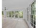 Bright sunroom with lots of windows offering views of mature trees at 4166 Riverhill Ne Ct, Roswell, GA 30075