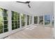 Bright sunroom with lots of windows offering views of mature trees and blue sky at 4166 Riverhill Ne Ct, Roswell, GA 30075