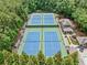 Community tennis courts surrounded by trees. Also features a nearby pool and seating area at 4402 Windsor Oaks Chase, Marietta, GA 30066