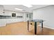 Basement features a foosball table in the recreation space and white cabinetry with granite counters at 4402 Windsor Oaks Chase, Marietta, GA 30066