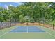 Outdoor basketball court features well-maintained surface and hoops, set amidst a backdrop of mature trees at 4402 Windsor Oaks Chase, Marietta, GA 30066