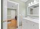 Bathroom with a marble vanity, mirror, and an adjacent workout space with cork floors at 4402 Windsor Oaks Chase, Marietta, GA 30066