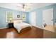 Bedroom featuring hardwood floors, light blue walls, ceiling fan and natural light at 4402 Windsor Oaks Chase, Marietta, GA 30066