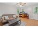 Well-lit bonus room with a futon, desk, ceiling fan, and wood-look flooring at 4402 Windsor Oaks Chase, Marietta, GA 30066