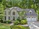Charming two-story home with a well-manicured lawn, mature trees and a two car garage at 4402 Windsor Oaks Chase, Marietta, GA 30066