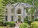 Close up of a home's facade with gray stucco, black trim, and arched windows at 4402 Windsor Oaks Chase, Marietta, GA 30066
