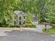 Charming home with a well-manicured lawn, mature trees, and a circular driveway at 4402 Windsor Oaks Chase, Marietta, GA 30066