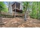 Multi-level house with a backyard featuring multiple decks and a wooded area at 4402 Windsor Oaks Chase, Marietta, GA 30066
