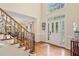 Foyer with hardwood floors and a staircase featuring wood and wrought iron detailing at 4402 Windsor Oaks Chase, Marietta, GA 30066