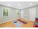 A versatile home gym space with ample natural light, mirrored wall, and cork flooring at 4402 Windsor Oaks Chase, Marietta, GA 30066