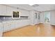 View of the kitchenette area with all-white cabinetry, granite counters, and natural lighting at 4402 Windsor Oaks Chase, Marietta, GA 30066