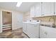 This well-equipped laundry room has a washer, dryer, sink, and storage space for all your laundry needs at 4402 Windsor Oaks Chase, Marietta, GA 30066