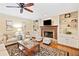 Inviting living room with a stone fireplace, built-in shelves, hardwood floors, and comfortable seating at 4402 Windsor Oaks Chase, Marietta, GA 30066