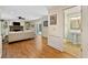 Spacious living room with hardwood floors, fireplace, built-in shelves, leading to a half bathroom at 4402 Windsor Oaks Chase, Marietta, GA 30066
