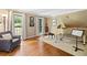 Bright living room with a white piano, hardwood floors, and large windows at 4402 Windsor Oaks Chase, Marietta, GA 30066