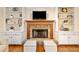 Living room featuring a stone fireplace flanked by built in bookshelves with hardwood floors at 4402 Windsor Oaks Chase, Marietta, GA 30066