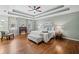 Charming main bedroom with hardwood floors, tray ceiling, and a decorative accent chair at 4402 Windsor Oaks Chase, Marietta, GA 30066