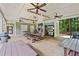 A covered outdoor kitchen features built-in grill, ceiling fans and picnic tables at 4402 Windsor Oaks Chase, Marietta, GA 30066