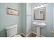 This elegant powder room features a pedestal sink, decorative mirror, and fresh paint at 4402 Windsor Oaks Chase, Marietta, GA 30066