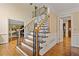 Classic staircase featuring wood steps, wrought iron railings, and elegant trim at 4402 Windsor Oaks Chase, Marietta, GA 30066
