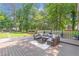 Lovely backyard featuring a wooden deck with comfortable patio seating surrounded by lush greenery and trees at 2048 Mcafee Rd, Decatur, GA 30032
