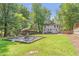 Expansive backyard view showcasing a fire pit and a nice deck at 2048 Mcafee Rd, Decatur, GA 30032